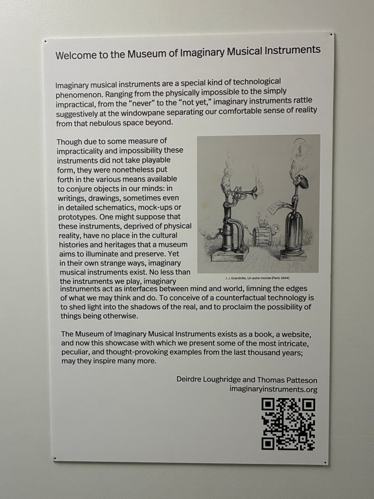 Sign introducing the Museum of Imaginary Musical Instruments, describing the concept and purpose of imaginary instruments.